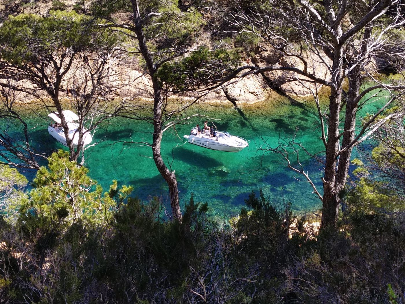 Photo of small boats on very green waters. Looks like the boats are floating in the air.