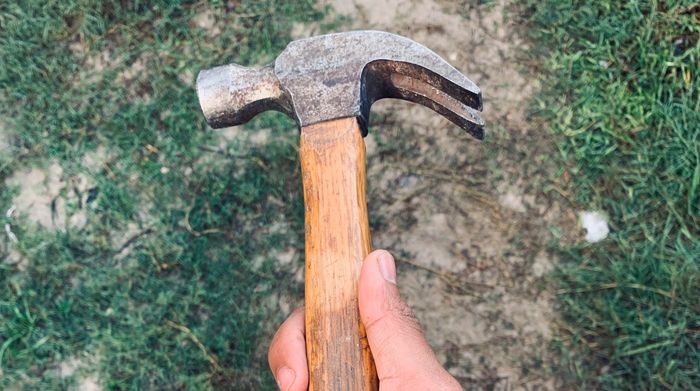 Photo of a hand holding a hammer
