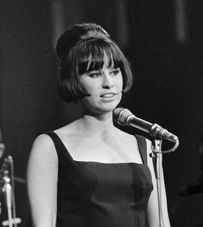 Black and white photo of Astrud Gilberto in front of a microphone