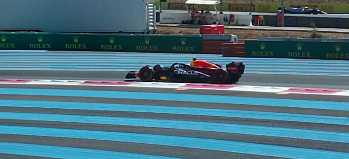 Photo of Max Verstappen's car driving by at Paul Ricard circuit
